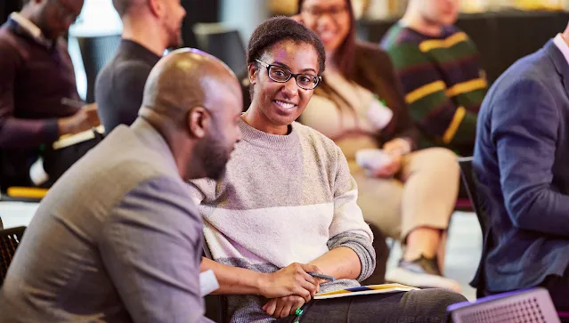Man and a woman sitting on a chair.