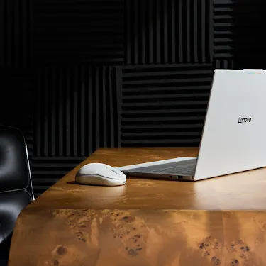 Googlebook open on a desk in a music studio with a mouse nearby.
