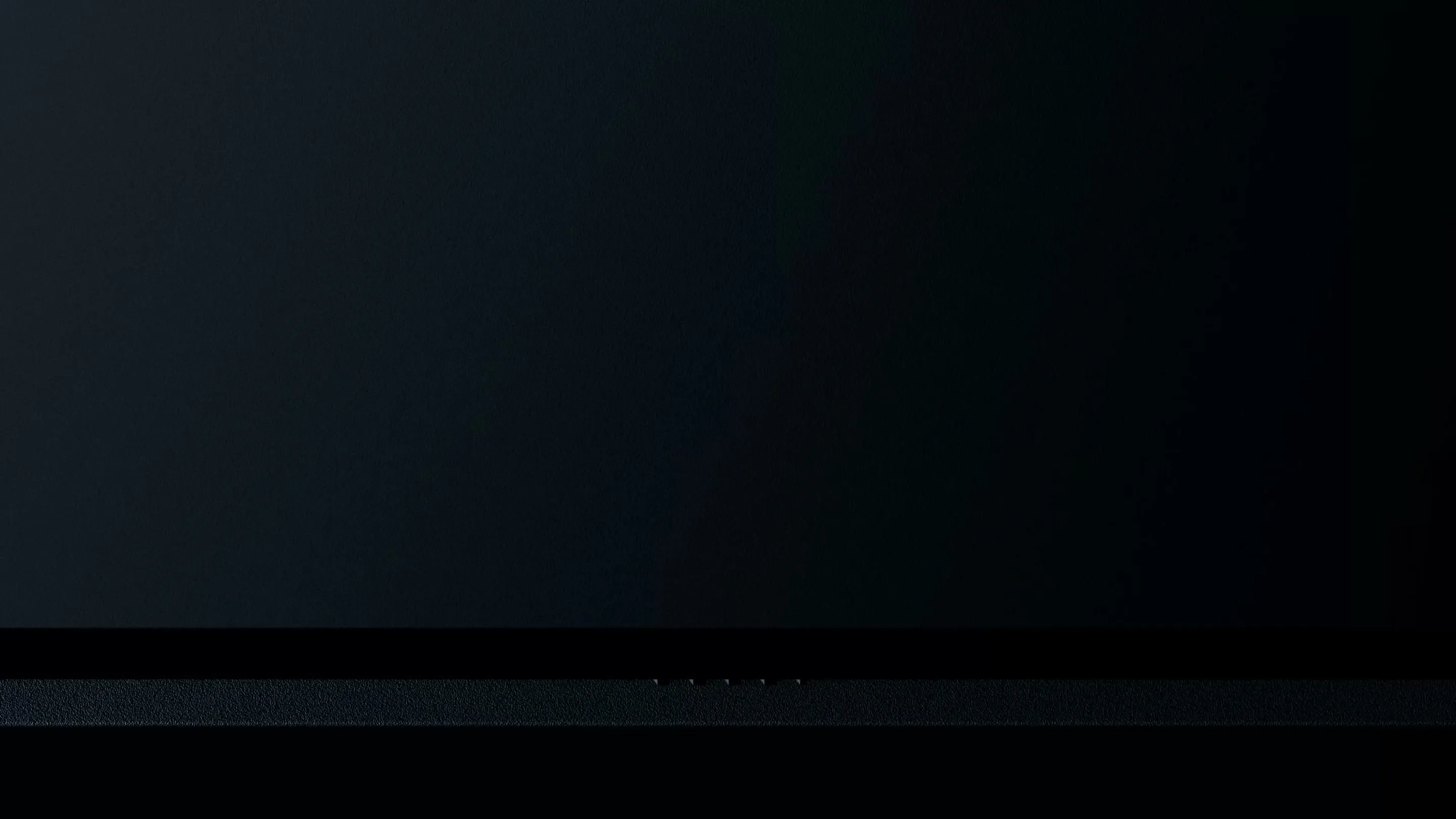 Close-up of the Googlebook glowbar lighting up as the device powers on.