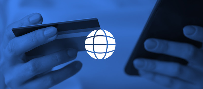 A person holding a mobile phone in one hand and a bank card in the other, conducting a financial transaction online