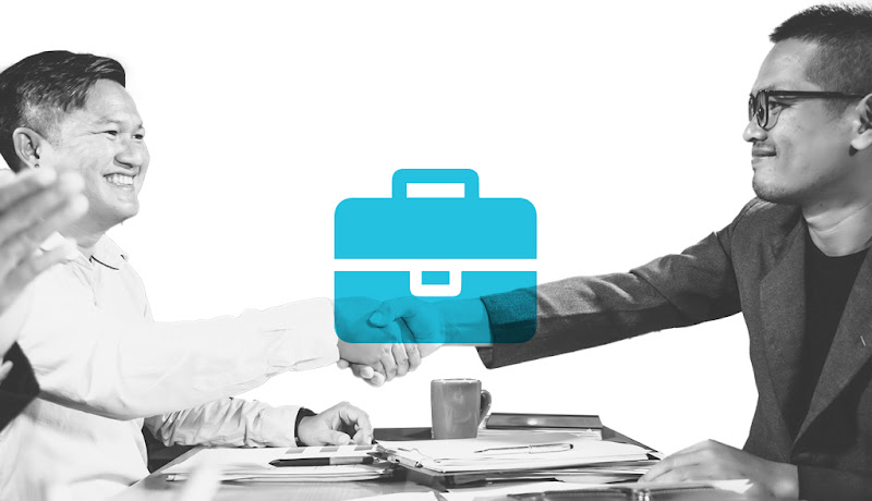 Two people shaking hands at a job interview