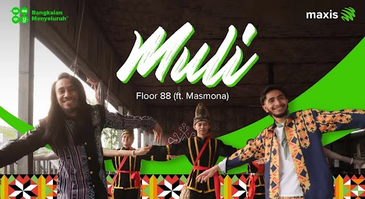 The thumbnail features five people, including two men in the foreground, performing a traditional cultural dance with outstretched arms in what appears to be a longhouse or community hall. They are wearing traditional and modernized Malaysian ethnic attire. Large green cursive text across the center reads "Muli (Floor 88 ft Nasmona)," and the top corners show the Maxis logo and a badge for 5G 4G Rangkaian Menyeluruh (Comprehensive Network).