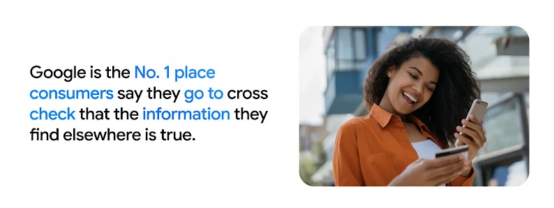 A woman smiles at her phone, holding a bank card, reflecting that in Australia, Google is the No.1 platform consumers use to cross-check information, highlighting the importance of search marketing in the consumer journey.