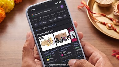 Hands holding a smartphone searching Google for 'makeup kit instant delivery', displaying fast delivery shopping results next to a festive Rakhi thali and marigold flowers.