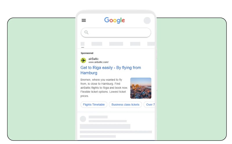 A Google search result is displayed on a smartphone screen, showing a sponsored ad for airBaltic. The ad text reads, "Get to Riga easily - By flying from Hamburg." The description suggests Bremen is close, so the user can fly from there.
