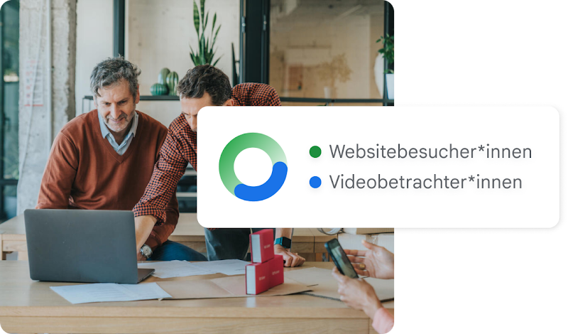 Zwei Männer benutzen einen Laptop, umgeben von einem Kreisdiagramm