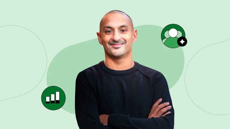 Vineet Mehra, CMO of Chime, smiles, arms crossed, in front of a green background with icons representing AI and growth. Mehra has medium brown skin, dark brown eyes, and a shaved head. He wears a black pullover.