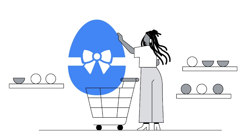 Uma mulher veste camiseta branca e calça cinza. Ela está em um supermercado e empurra um carrinho de compras, entre prateleiras com ovos de Páscoa. Ela escolhe um grande ovo de Páscoa com embalagem azul e um laço.