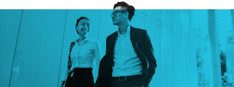 Two Hong Kong working professionals smiling and talking while walking side-by-side