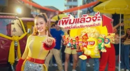 The video thumbnail shows four Thai celebrities/artists (Kratae, Sianrang, Liu Ajariya, and Lily) posing together in a bright, festive scene, surrounded by bags of Lay's potato chips to promote the increased quantity.
