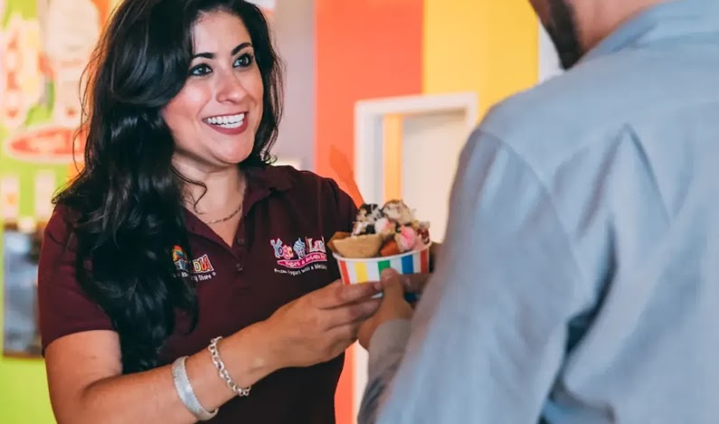 A customer being served at Yogolandia Yogurt and Botana Bar.