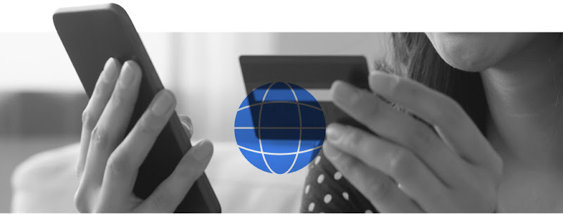 A Hong Kong woman holding a mobile phone in one hand and a bank card in the other to conduct a financial transaction online