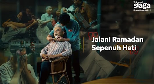 A video thumbnail showing a young man warmly comforting an older man seated in a chair, with text reading "Jalani Ramadan Sepenuh Hati".