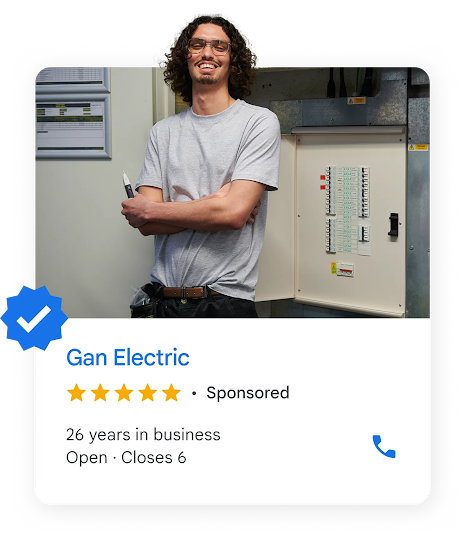 A local ad shows an electrician with long wavy hair standing next to a breaker  box.