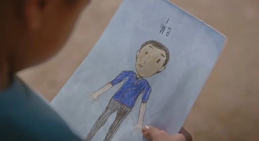 The video thumbnail shows a dramatic, emotionally intense scene between two main characters (a father and son or two men in a rural setting), promoting Café Amazon as "the coffee that's fair to everyone."