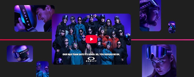 Oakley promotional video thumbnail featuring a large group of winter athletes in goggles and gear under purple lighting. Text reads: "OUR R&D TEAM SAYS IT'S GOOD. SO, YOU SHOULD BE OK." and includes the Oakley logo. A red play button sits in the center.