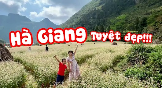 The video thumbnail shows the vlogger and his young son, Sâu, standing by a scenic road in a mountainous region of Hà Giang, Vietnam, during their trip to distribute NutriFood milk.
