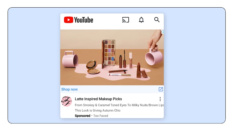 A still from a YouTube ad for Too Faced’s latte inspired makeup picks. A and is tipping a mug, as if make-up has spilled over the surface. Another mug is spilling makeup. Various accessories are visible, including a pallet with different shades of bronze.