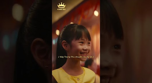 A vertical video thumbnail of a smiling young girl in a yellow top, featuring a gold Kinh Do logo and Vietnamese song lyrics about the Mid-Autumn Festival.