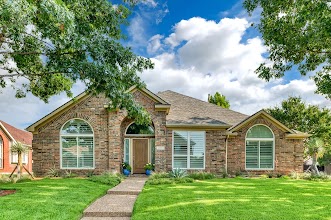 Outside of a brick home with newly replaced windows.