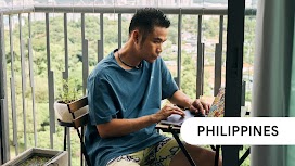 Philippines. A man uses his laptop by the balcony at home for Search.