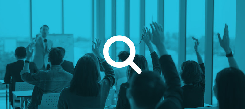 Multiple people raising their hands at once during a professional presentation