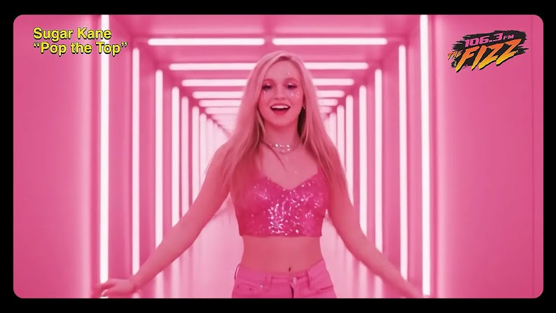 An AI-generated pop star, Sugar Kane, appears in a music video for “Pop the Top,” an AI-generated song. Sugar Kane looks very similar to real-life pop star Britney Spears, with long blonde hair and dressed in a pink crop top and jeans.
