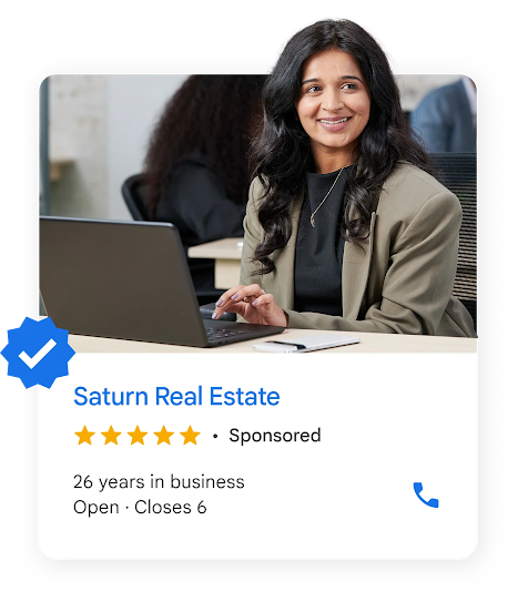 A local ad shows a realtor working on a laptop.