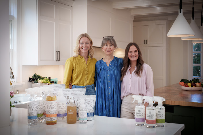 Branch Basics family poses in a kitchen with their products displayed.