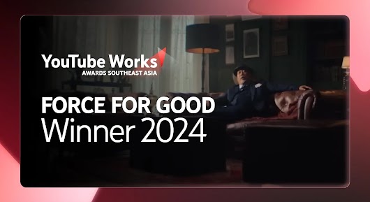 A man in a suit and flat cap is dramatically reclining on a dark leather sofa in a dimly lit, richly decorated room. Large white text is overlaid on the left side of the screen, reading: "FORCE FOR GOOD Winner 2024," along with the YouTube Works Awards Southeast Asia logo.