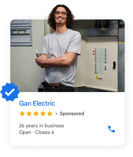 A local ad shows an electrician with long wavy hair standing next to a breaker  box.