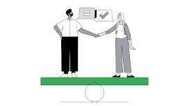 Un uomo e una donna si tengono per mano. Si trovano in piedi sopra a un piano, verde, in equilibrio sopra a una sfera.