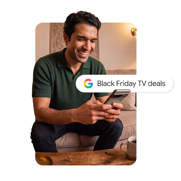 A graphic of a smiling man sitting on a couch, using a smartphone with a Google search bar overlay that reads "Black Friday TV deals."