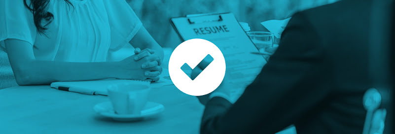 An interviewer referring to a resume in front of a job seeker during a job interview