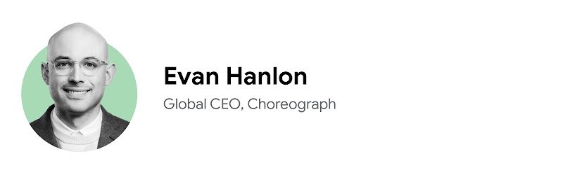 Evan Hanlon, CEO internacional de Choreograph, sonríe en una foto en primer plano en blanco y negro sobre un fondo verde pálido. Tiene la piel clara y los ojos oscuros, y lleva gafas con montura metálica, un jersey fino sobre una camisa de cuello blanco y