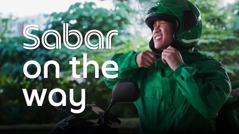 YouTube Works Awards Southeast Asia 2026 Winner card for the 'Best of Festive' category, showcasing Grab Malaysia’s campaign 'Sabar’s On The Way' by M+C Saatchi Performance, Grab Creative Studio, and Layar Lucida. The visual depicts a hand holding a smartphone showing a humorous customer interaction with a Grab driver named Sabar.