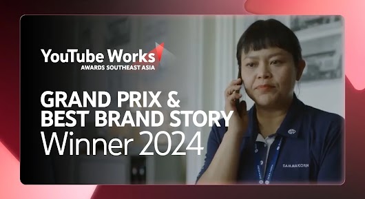 A woman with short hair, wearing a dark blue polo shirt with a company logo, is shown in a close-up, talking on a mobile phone indoors. Large white text overlays the left side of the image, reading: "GRAND PRIX | BEST BRAND STORY Winner 2024," along with the YouTube Works Awards Southeast Asia logo. 