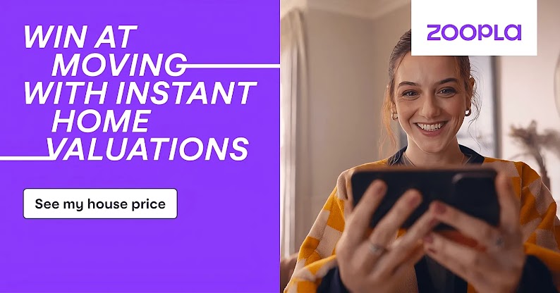 A still from Zoopla’s “Win at Moving” campaign. On the left, copy reads: “Win at moving with instant home valuations”. Below, more copy reads: “See my house price”. To the right, a woman holds a mobile phone in both hands and smiles widely at the screen.