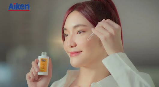 The video thumbnail depicts a brightly lit, outdoor scene featuring a group of young women, wearing casual sports attire, posing to show off their visibly bright and luminous skin.