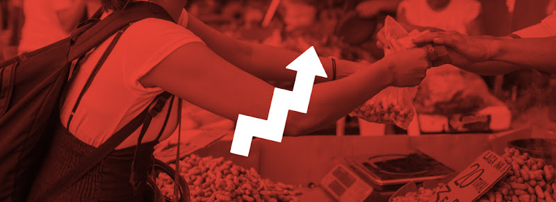 A woman purchasing ingredients at a market in the Philippines