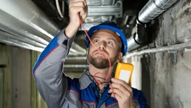 A man doing commercial electrical work.