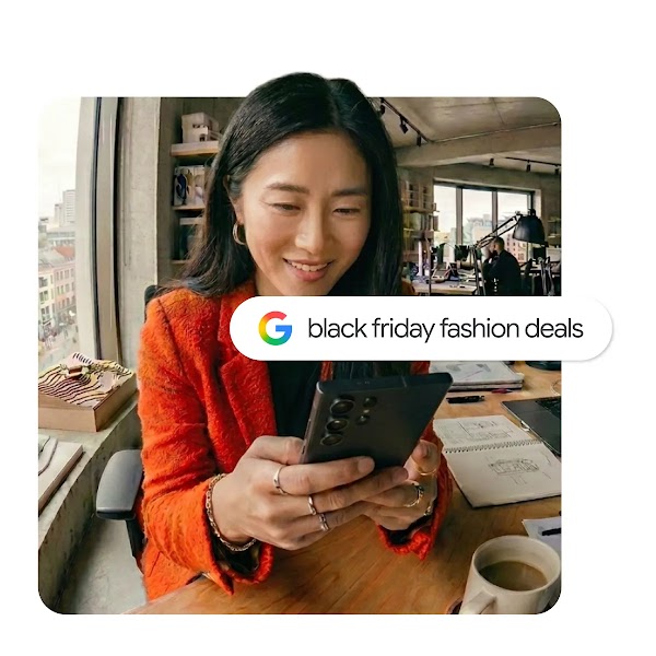A woman in an orange jacket looking at her smartphone in a bright office, overlaid with a Google search bar reading "black friday fashion deals".