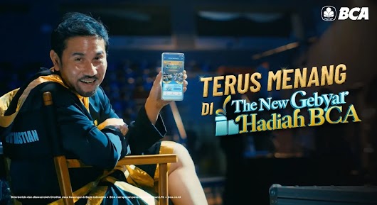 A promotional video thumbnail for BCA showing a smiling man sitting in a chair holding up a smartphone, with text reading "TERUS MENANG DI The New Gebyar Hadiah BCA".