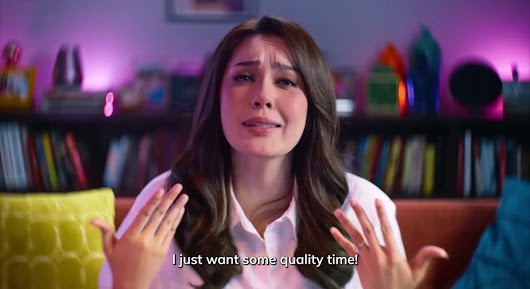 A video screenshot of a distressed woman in a white shirt pleading to the camera, with subtitles reading "I just want some quality time!".