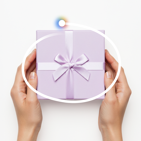 A pair of hands holds a silver-gray gift box, tied with a satin ribbon. The box is circled by a white line and the radiant icon for Circle to Search. 