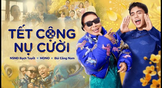 A festive music video thumbnail featuring two smiling singers in blue outfits next to large text that reads "TẾT CỘNG NỤ CƯỜI" against a bright yellow background