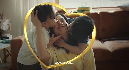 The video thumbnail shows a mother and her child in a heartwarming embrace or activity, promoting NIDO 3+ 5+ milk.