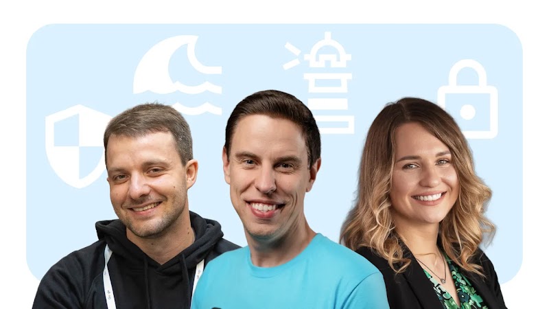 Three smiling people posing side by side against a light blue background featuring white security and ocean icons: a shield, a fin in waves, a lighthouse, and a padlock.