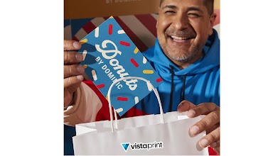 A VistaPrint customer showing his custom cards for Donuts by Dominic.