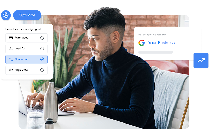 A man wearing a blue turtleneck sets up his next Google Ads campaign on his laptop.